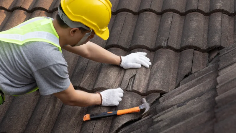 Nahaufnahme eines Bauarbeiters, der auf einem Dach arbeitet